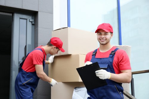 Professional movers handling furniture in a Tolworth flat