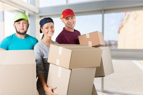 Professional movers handling household furniture in a Tolworth property