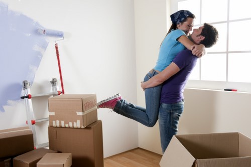 Local moving team organising boxes in a Tolworth property