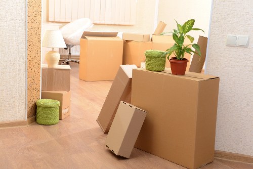 Packed moving boxes and furniture ready for collection in Tolworth