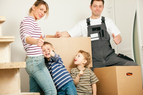 Packed boxes and mover planning a household relocation in Tolworth